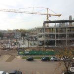 Construction site showing the structural steel framework between the two wings, the five lobby columns (up to the second-floor level) and the door frame for the main entrance.